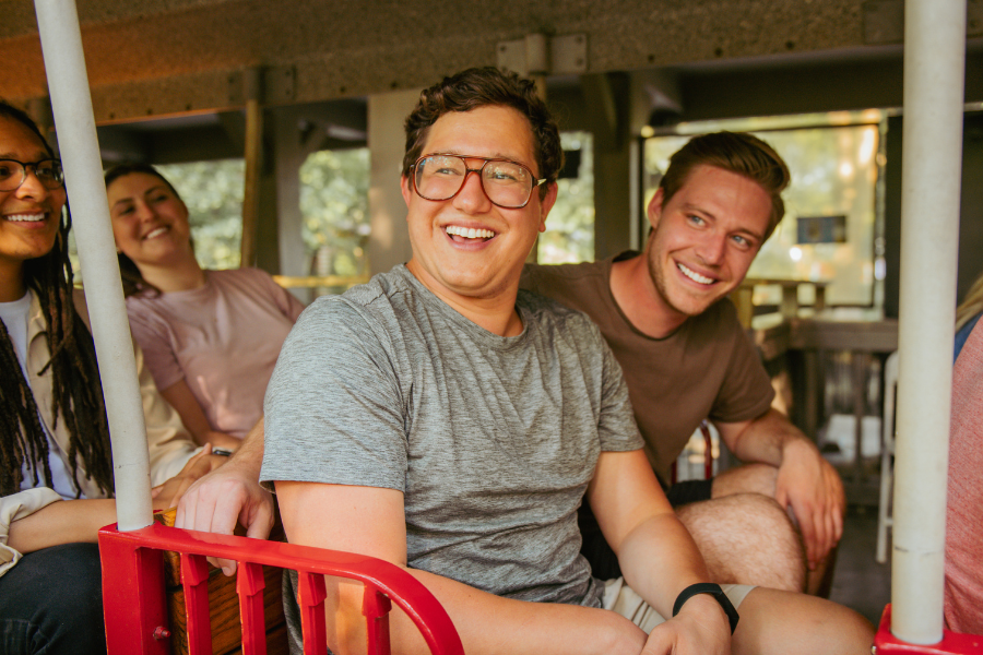 two boys on a train with a man and female behind the boys